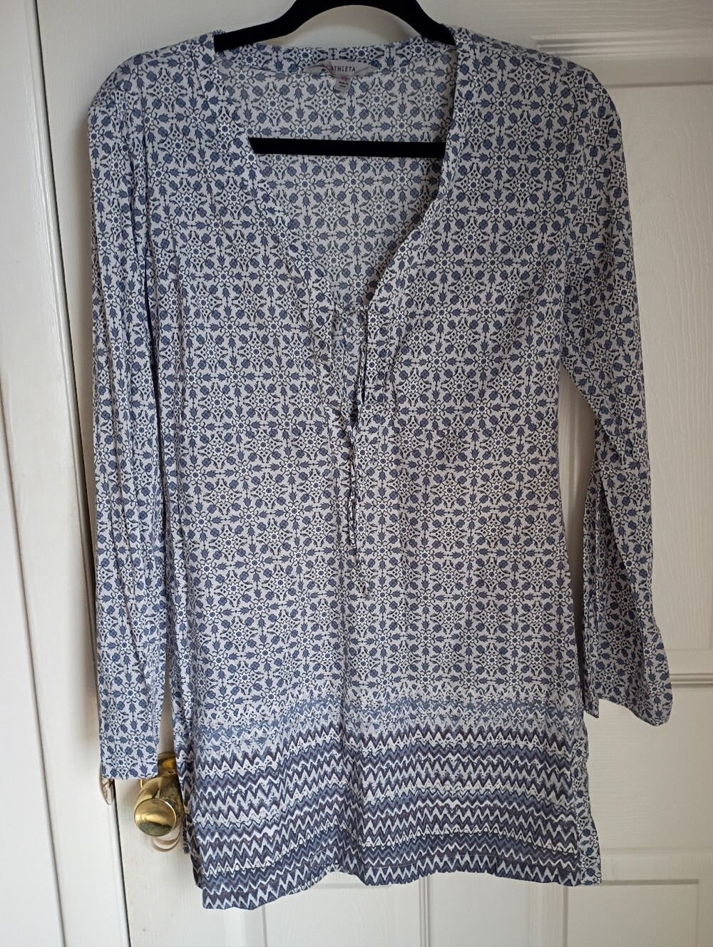 Athleta blue and white patterned V-neck tunic with a tie detail and long sleeves